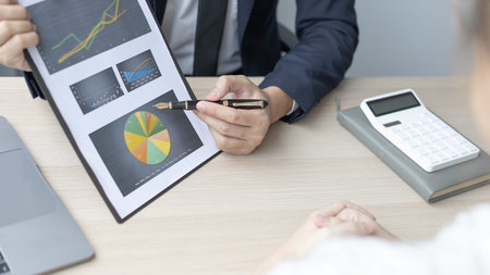 Brainstorm team, Marketers and financial accountants are discussing and analyzing charts to plan...