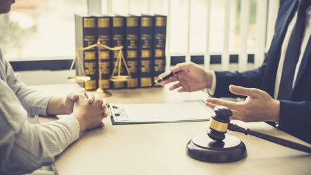 Attorney or judge provides legal advice to the client in the courtroom, Ethics in the courts include justice and impartiality, legal consultant, scales of justice, law hammer, Litigation and justice.の写真素材