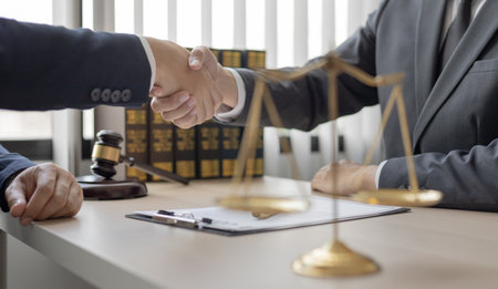 Businessman shaking hands with a lawyer or judge After signing the contract and the agreement is complete, Approval of an agreement between business and law, End of the legal case.の写真素材