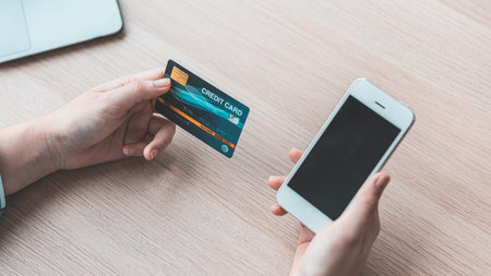 Women use smart phone to register online purchases using credit card payments, Technology for the...