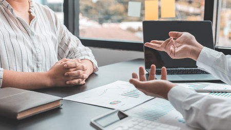 Brainstorm team, Marketers and financial accountants are discussing and analyzing charts to plan strategies to meet customer needs, Business data graph, Team meetings or business consulting.の写真素材