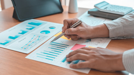 Asian businessmen are analyzing graphs, Financial statistics and calculating corporate returns in private offices, Market research reports and income statistics, Financial and Accounting concept.の写真素材