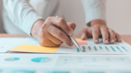 Asian businessmen are analyzing graphs, Financial statistics and calculating corporate returns in...