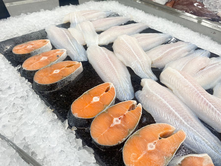 Tesco Lotus,THAILAND- August 25, 2021 : Variety of fresh meat, Fresh fish and seafood are placed in trays or on crushed ice, Fresh food products in famous department stores. Food in the mall.のeditorial素材
