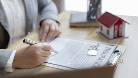 Selling a house with insurance, Sales managers or dealers have signed approval to open a housing project with a model house, Home-Real Estate and Insurance concept.の写真素材