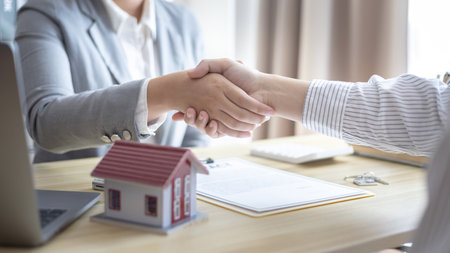 Business success, Real estate agents and customers shake hands to congratulate after signing a contract to buy a house with land and insurance, handshake and Good response concept.の写真素材