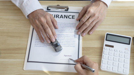 Dealer or manager gives the car to the customers who sign the car purchase documents with insurance, Signing a contract to buy a car that is legal, Document signing and credit approval Concept.の写真素材