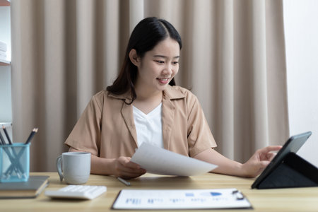 Women are greeting friends and teachers through video chats and greeting them with cheerful expressions, Online communication , Stay home, New normal, VDO Call, Social distancing, Internet learning.の写真素材