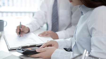 Brainstorm team, Marketers and financial accountants are discussing and analyzing charts to plan strategies to meet customer needs, Team meetings or business consulting.の写真素材