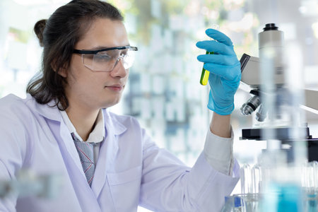 Laboratory diagnosis of synthetic substances, Scientist or researcher examines the substance in vitro and record information, Lab experiments, Researchers scientist working analysis with test tube.の写真素材