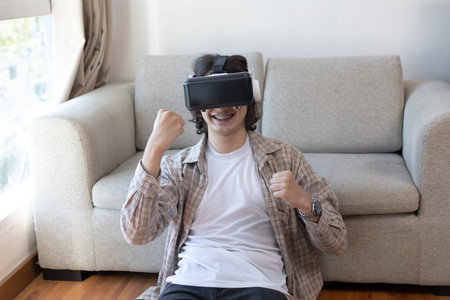 Man wearing virtual reality glasses is playing a 3D game with excitement, Man in glasses of virtual...