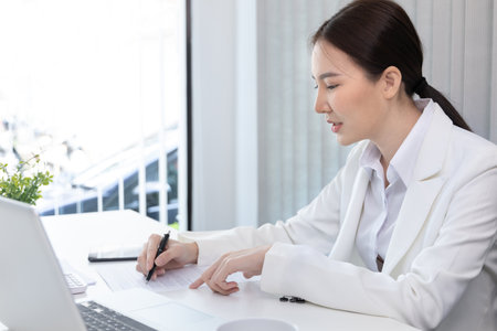 Financial businesswoman analyze the graph of the company's performance to create profits and growth, Market research reports and income statistics, Financial and Accounting concept.の写真素材