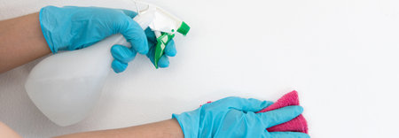 Employee's hands were wiping the white walls, use a towel moistened with cleaning solution to rub...