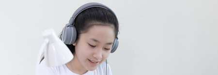 Asian girl is studying online via the internet with a cheerful smile, stay home, New normal,...