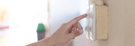 Close up young man's hand pressed the button to turn on the light switch, Open the electrical...