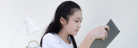 Asian young woman reading in a private room, Quarantine during the outbreak of the new virus, stay...