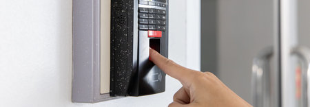 Finger print scan, Male employees press sensors to record company attendance time and after work,...