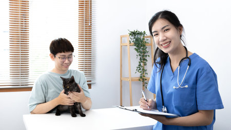 Veterinarian or animal nurse is checking the cat's health and Consulting pet owners for cat health in the hospital, Save animals, Care and treatment, Animal hospital.の写真素材
