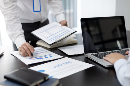 Brainstorm team, Marketers and financial accountants are discussing and analyzing charts to plan strategies to meet customer needs, Business data graph, Team meetings or business consulting.の写真素材