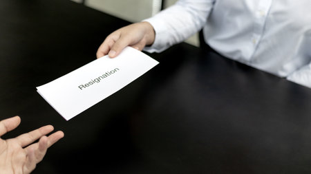 Employee submits the resignation letter envelope to the head of personnel, Carrying a box of work equipment home, Can't bear the burden or pressure, Employment contract is expired.の写真素材