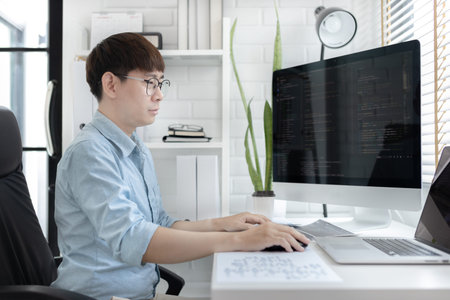 Professional development programmers are sit on a desk with work equipment such as:...
