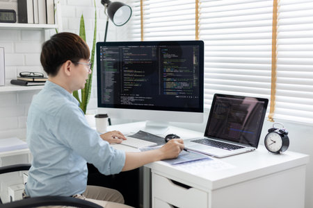 Professional development programmers are laying out a structure or draft on paper in preparation for coding on a computer, Write information or code for the website,  HTML, javascript, Software.の写真素材