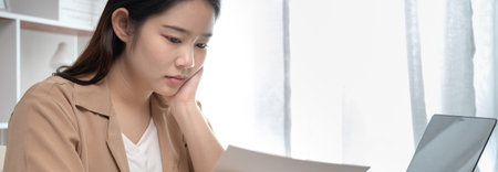 Young Asian women are greeting friends and teachers through video chats and greeting them with cheerful expressions, Online communication , Stay home, New normal, work for home, Internet learning.の写真素材