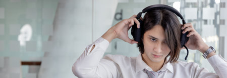 Businessman are greeting friends and manager through video chats and use headphones for...