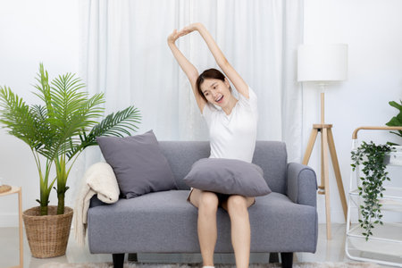 Asian woman taking notes in notebook while studying online in laptop or tablet  at home, Video chat, Online communication , Stay home, New normal, Distance learning

, Social distancing, Learn online.の写真素材