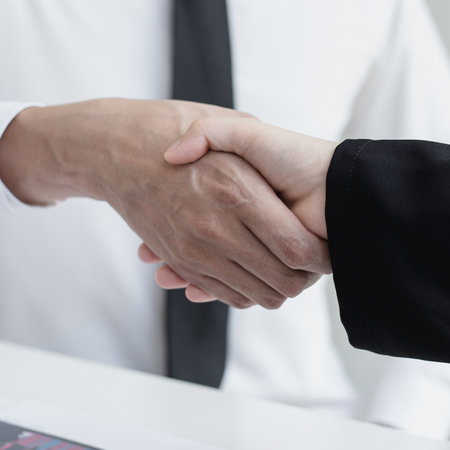 Financial accountants and marketers shaking hand to congratulate the double-digit real estate performance, Meetings and hand shake concept.の写真素材