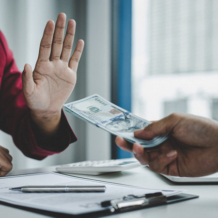 Businessmen give dollars to bribe employees in signing contracts to buy illegal land and real estate, Business fraud and social injustice, Anti Bribery and corruption concept.の写真素材