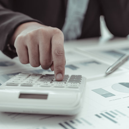 Businesswomen are calculating finances and analyzing market data with graphs and laptops at work, Business Financing Accounting Banking and tax system Concept.の写真素材
