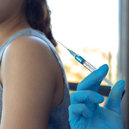 Vaccination of patients, Doctor provided a vaccine with a syringe against a new strain of  virus or...
