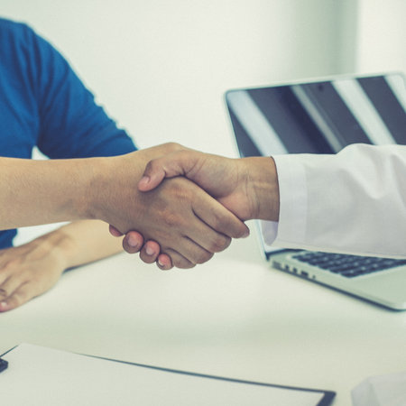 Doctors and patients shook hands after the results of the treatment improved and healed, Congratulation and success concept.の写真素材