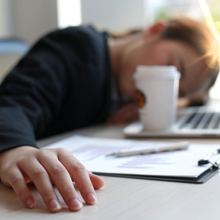 The financial accountant works on analyzing and summarizing the company's incomes and expenses in real estate and account management, causing her to get tired and fall asleep on her desk, Hard work and overtime work concept.の写真素材