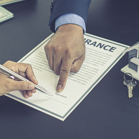 Real estate agent or sales manager has proposed terms and conditions to customers who sign house purchase agreements with insurance, Agreement to sign the purchase contract concept.の写真素材