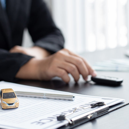 Car sales representative or sales manager submits a car key to a client who has approved financial loans with the company, Approval of financial and banking loans concept.の写真素材