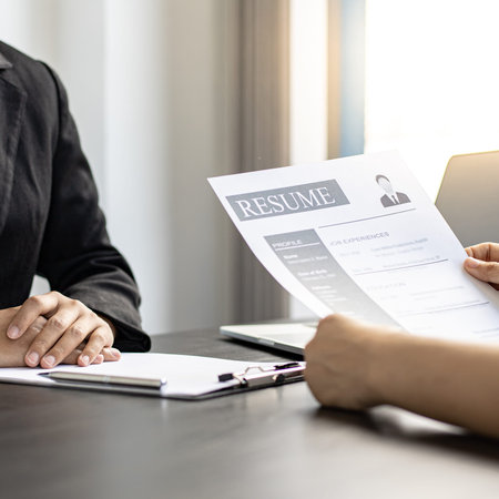 Employer or HR department is reading the resume and interviewing the ability of new employees, Employer is selecting job applicants, Employment and Recruitment Concept.の写真素材