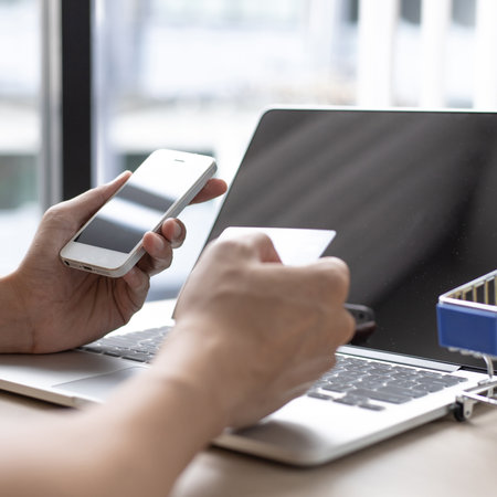 Businessman use mobile phones to register for security Online with a credit card to buy products online through application,Online shopping or Internet technology concept.の写真素材