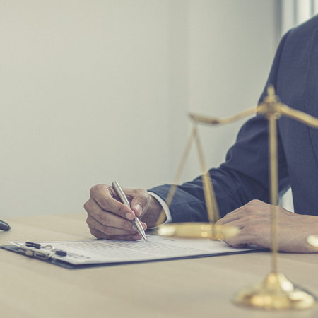 Judge or a lawyer works documents in the courtroom and analyze the various laws for justice and...