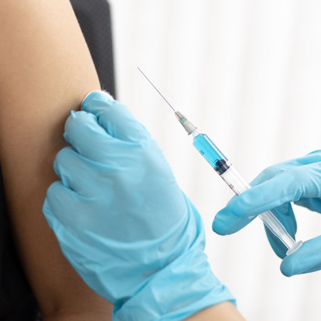 Doctor is vaccinating women with antibiotics or new antibodies to prevent the spread of the virus, Vaccination against communicable diseases conceptの写真素材