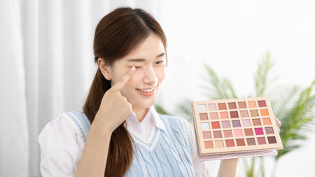 Beautiful women with social media influences are teaching makeup and use cosmetics, In front of the camera to recording vlog video live streaming, Online business on concept of beauty bloggers.の写真素材