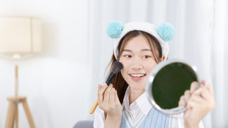 Beautiful women with social media influences are teaching makeup and use cosmetics, In front of the camera to recording vlog video live streaming, Online business on concept of beauty bloggers.の写真素材