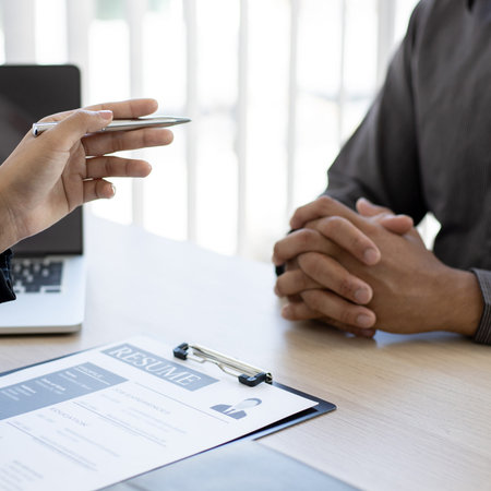 Managers or HR departments read resume and interview applicants for selection as a company real...
