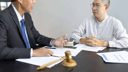 Attorney or judge provides legal advice to the client in the courtroom, Ethics in the courts include justice and impartiality, Legal consultant, Scales of justice, Law hammer, Litigation and justice.の写真素材