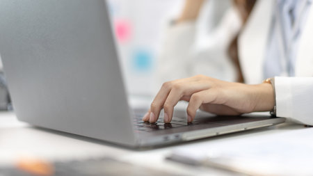 Businesswoman's hand presses on a laptop keyboard, World of technology and internet communication,...