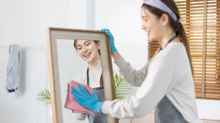 Beautiful housewife is cleaning things and Wipe the mirror in her dressing room, Big cleaning, Housework, Daily routine ,Removes germs and dirt and deep stains, Spray alcohol, Clean up on weekends.の写真素材