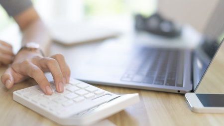 Businesswoman presses a calculator to calculate earnings and analyze company earnings in his private...