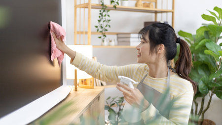 Housewife is cleaning things and Storage cabinet or showcase in the living room, Big cleaning, Housework, Daily routine ,Removes germs and dirt and deep stains, Spray alcohol, Clean up on weekends.の写真素材