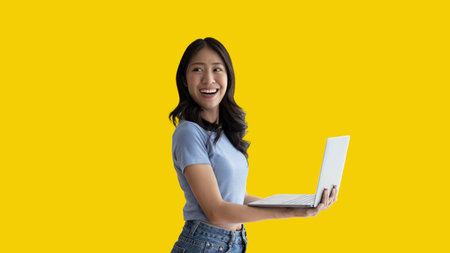 Asian woman in casual clothes holding working laptop in freelance work concept with single laptop can earn money, Invitation to apply or register to receive special privileges and prizes.の写真素材